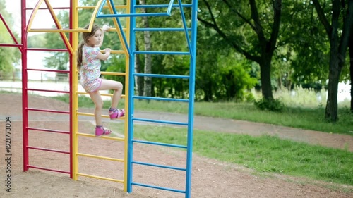 Wallpaper Mural Small beautiful girl is engaged on horizontal bars Torontodigital.ca