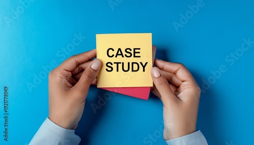 hands holding a sticky note with the words case study on a blue background