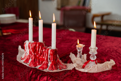 Tableau sur toile Candles wax drips centerpiece on velvet