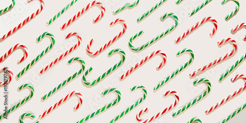 Overhead view of red and green candy canes arranged in a repeating pattern