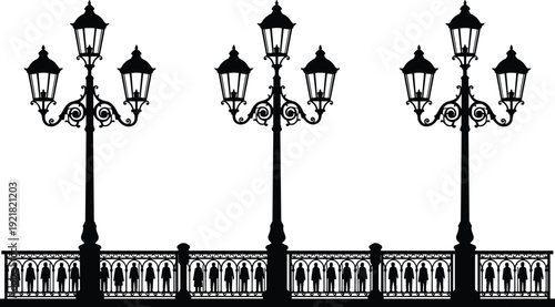 Black silhouette of street lamps and people on a bridge railing