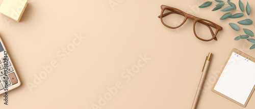 Minimalist workspace with calculator, glasses, pen, notepad, and leaves on beige background, creating calm and organized atmosphere for productivity and focus