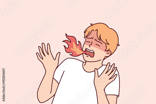 Man exhaling fire after eating spicy chili pepper. Concept of extreme heat, burning sensation, and spicy food challenge reaction.