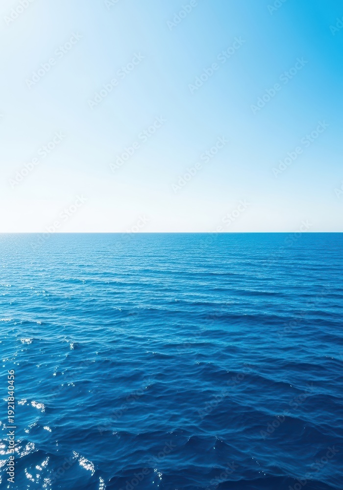 Obraz premium A sweeping view of the deep blue ocean water meeting the horizon on a clear, sunny day, emphasizing the massive scale of the water body, travel, clear, aquatic