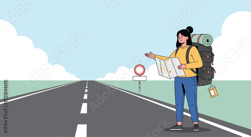 Young female backpacker stands by a long empty road through the countryside holding a map and waiting to hitchhike for her next travel adventure.