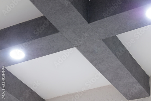 Fotografie Modern ceiling design with intersecting dark gray beams and recessed lighting