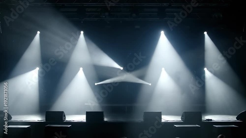 Dynamic Stage Lighting Illuminates a Dark Concert Venue with Bright Beams and Haze.