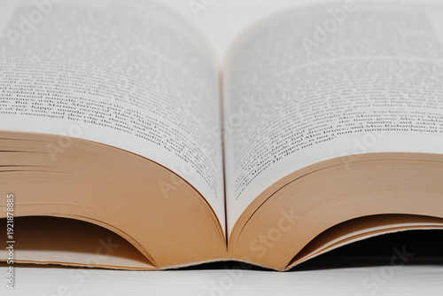 thick book open in middle, white pages