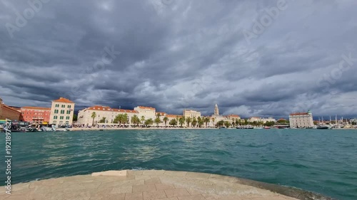 Riva promenade with Diocletian palace and old town in Split, Croatia on the Adriatic sea, dramatic sky