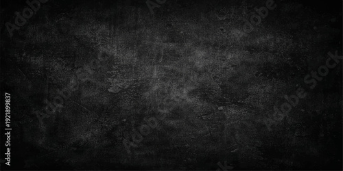 A vintage dark grey grunge paper background with a blank black chalk texture on an old dirty concrete wall surface for a textured design backdrop