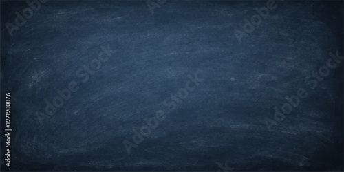 A dark blue chalk board with a grunge textured surface and vintage denim canvas pattern creates a rough blue wallpaper backdrop