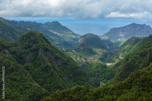 Aerial view over a green valley with lush Laurissilva vegetation in the mountains of the isle of Madeira