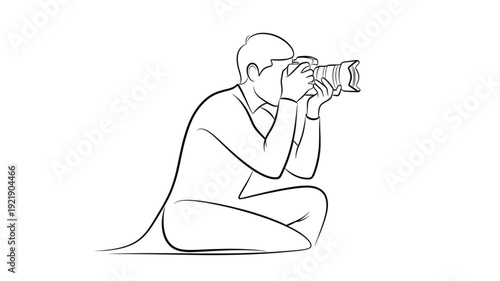 Man crouching and taking a picture with a professional camera.