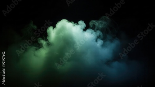 Heavy green and blue colored fog cloud billowing in dark empty space