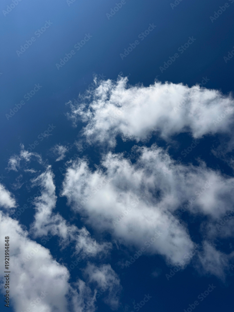 Obraz premium Puffy white clouds in blue sky.