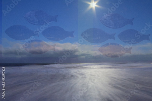 Winter sunset over the ocean with transparent fish swimming in the sky