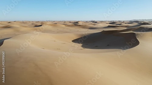 Magnificent expanse of sand dunes under a vast blue sky in the desert