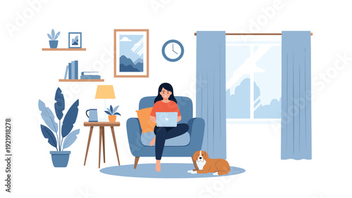 Young woman works from home on a laptop while sitting in a blue armchair with her brown and white dog nearby.