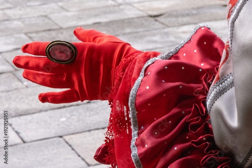 Elegant Venetian Masked Woman in Red and Silver Traditional Carnival Costume