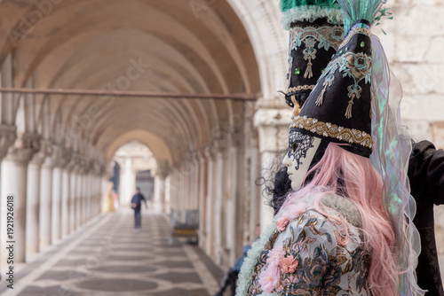 Elegant Masked Couple in Period Costumes by the Canal During Venice Carnival