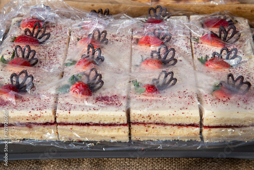 Slika na platnu homemade cakes, wrapped in cling film at the market