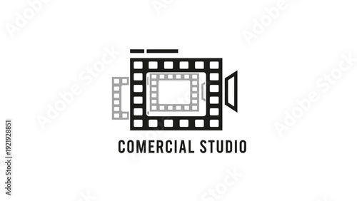 A stylized film reel design with a camera lens element, with the words "COMERCIAL STUDIO" beneath