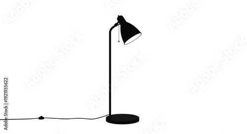 A black adjustable desk lamp stands isolated on white.