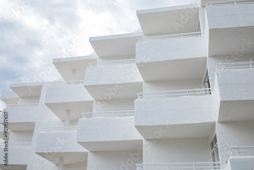 Quadro em tela White minimalistic hotel building exterior with symmetrical balconies on Mallorca island in Spain close up