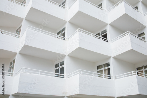 Quadro em tela White minimalistic hotel building exterior with symmetrical balconies on Mallorca island in Spain close up