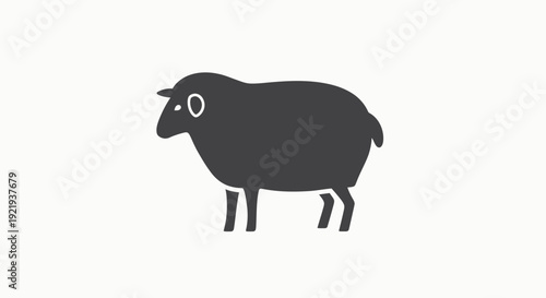 Black sheep standing alone profile view.