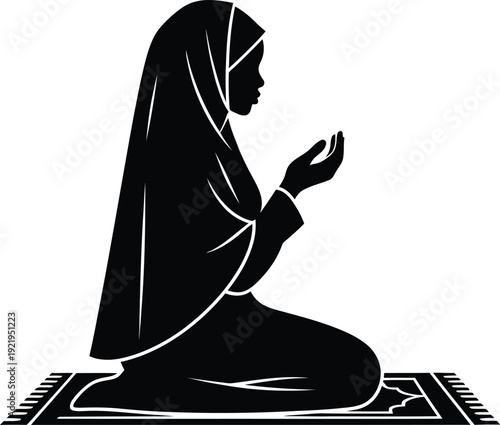 A muslim woman in prayer kneeling on a mat silhouette