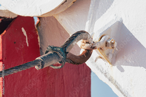 Steel cable secured with metal shackle on ship structure concept of connection and strength