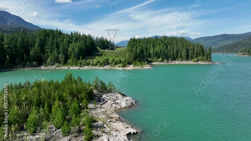 Aerial Over Turquoise Green Lake with Power Lines and Forested Island, Whistler BC