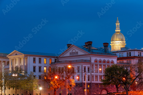Illuminated NJ state capitol complex with golden dome at night in Trenton, New Jersey, USA