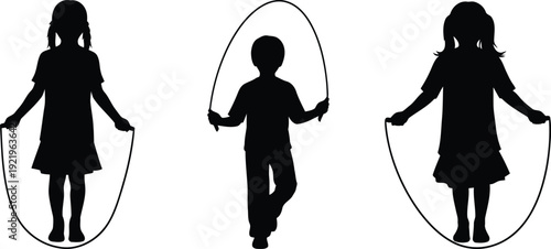 Children playing with jump ropes in silhouette