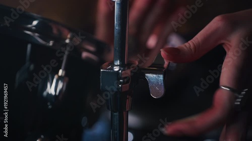 Unrecognizable musician installing cymbal in recording studio. Drummer hands assembling drum kit in concert hall. Emotional artist twisting butterfly nut screw in music studio. Fix problem