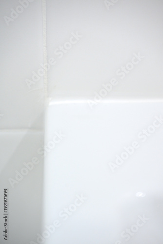 Wallpaper Mural Close-up of white bathtub corner against tiled wall in bathroom Torontodigital.ca