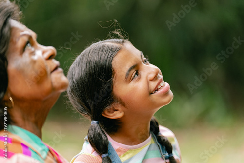 grandfather walking in the park with his beloved granddaughter