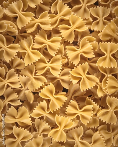 Seamless pattern of uncooked farfalle pasta texture background