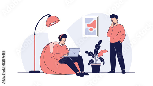 Comfortable home office setting with one man working on a laptop in a beanbag chair while another man watches him.