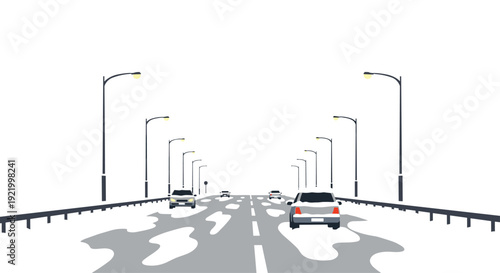 A wide perspective shot displays a modern highway with multiple cars driving and illuminated streetlights, featuring patches of melting snow on a winter day.