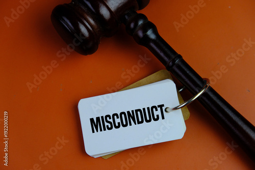 the judge's gavel and a paper tag with the word misconduct. law and regulation concept
