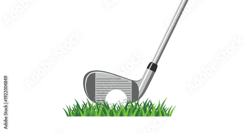 A close-up view of a silver golf club about to strike a white golf ball nestled in vibrant green grass against a white background.
