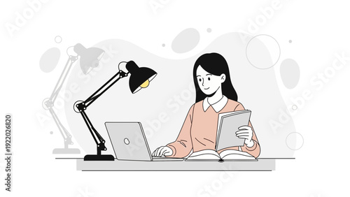Woman studying online with laptop and book, desk lamp illuminating workspace