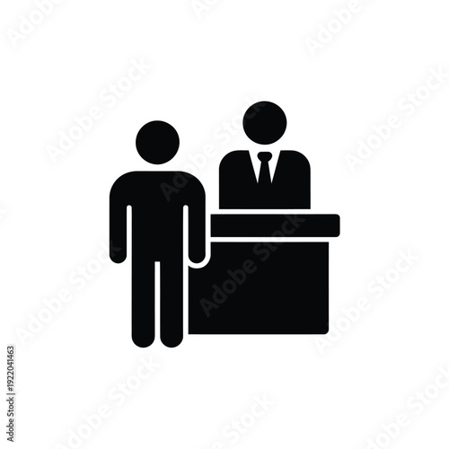 Simple black icon depicting a person at a reception desk