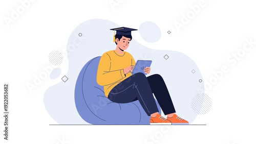 Student in graduation cap using tablet on beanbag chair, online learning concept