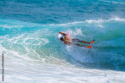 Fotografie Full body photo of male bodyboarder suspended on face of tropical wave