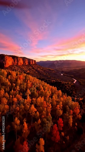 Golden Autumn Forest and River Valley at Sunset with Vibrant Orange and Pink Sky and Canyon Cliffs