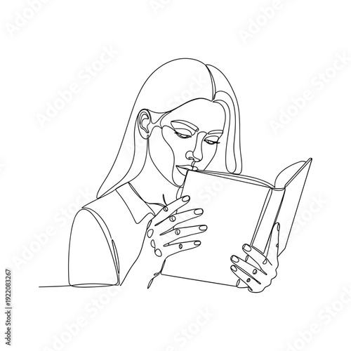 Woman deeply engrossed in reading a book with a pen in her mouth