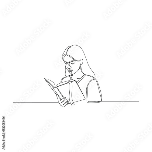 Woman engrossed in reading a book with focused expression